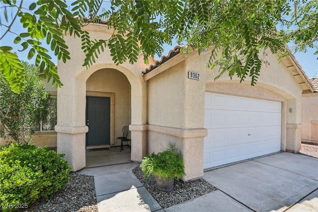 9362 Baltinglass St, Las Vegas, NV 89123 - entrance to property with stucco siding, a tiled roof, a garage, and driveway