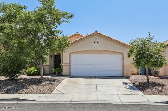 9362 Baltinglass St, Las Vegas, NV 89123 - mediterranean / spanish house with stucco siding, driveway, a garage, and a tile roof