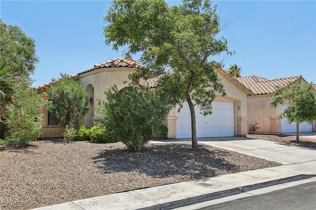 9362 Baltinglass St, Las Vegas, NV 89123 - mediterranean / spanish house featuring a tiled roof, concrete driveway, stucco siding, and an attached garage