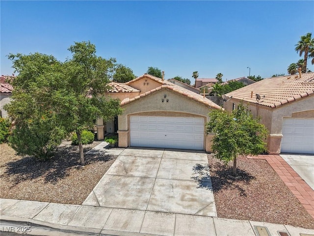 9362 Baltinglass St, Las Vegas, NV 89123 - mediterranean / spanish-style home with concrete driveway, stucco siding, a garage, and a tile roof