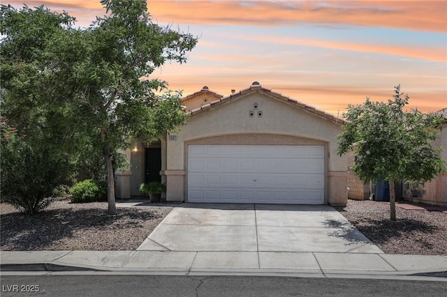 9362 Baltinglass St, Las Vegas, NV 89123 - mediterranean / spanish house with driveway, stucco siding, and a garage