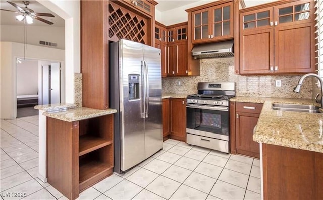 4466 New Dupell Way, Las Vegas, NV 89147 - kitchen with stainless steel appliances, extractor fan, light tile patterned floors, a ceiling fan, and brown cabinetry