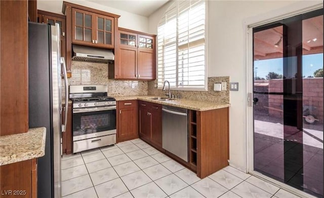 4466 New Dupell Way, Las Vegas, NV 89147 - kitchen with stainless steel appliances, ventilation hood, decorative backsplash, light tile patterned flooring, and light stone countertops