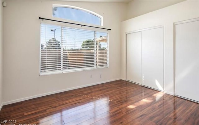 4466 New Dupell Way, Las Vegas, NV 89147 - unfurnished bedroom with wood finished floors and two closets