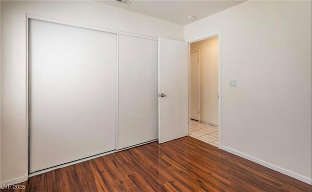 4466 New Dupell Way, Las Vegas, NV 89147 - unfurnished bedroom featuring wood finished floors and a closet