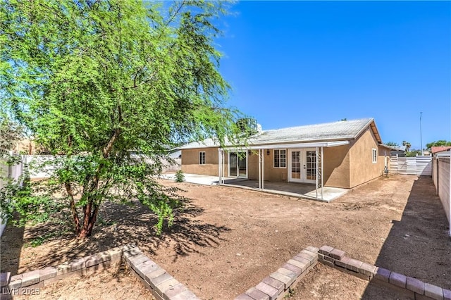 3887 Delling Ct, Las Vegas, NV 89104 - rear view of house with french doors, a patio area, a fenced backyard, and stucco siding