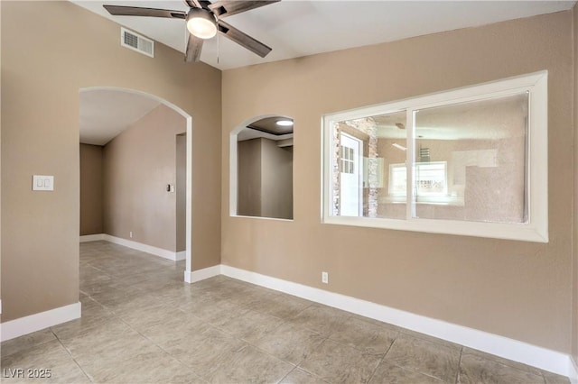 3887 Delling Ct, Las Vegas, NV 89104 - spare room featuring arched walkways, ceiling fan, and light tile patterned floors