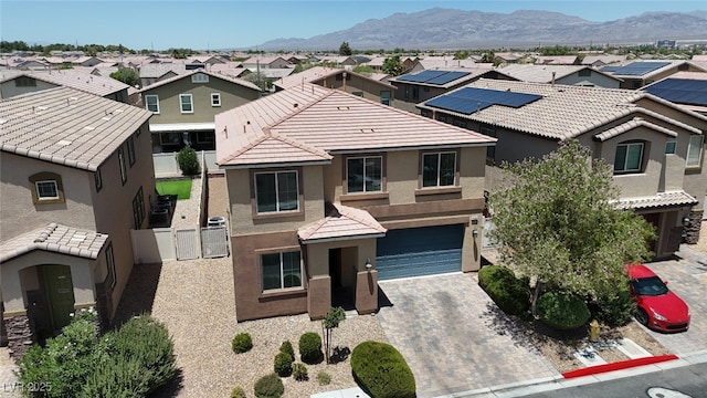 5309 Golden Melody Ln, North Las Vegas, NV 89081 - traditional home with stucco siding, a residential view, an attached garage, decorative driveway, and a mountain view