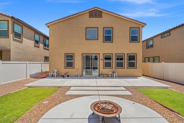 5309 Golden Melody Ln, North Las Vegas, NV 89081 - rear view of house featuring an outdoor fire pit, stucco siding, and a fenced backyard