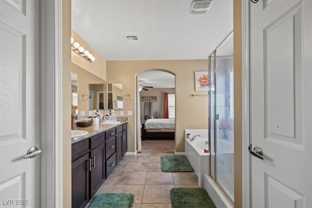 5309 Golden Melody Ln, North Las Vegas, NV 89081 - full bathroom with double vanity, a stall shower, tile patterned flooring, a ceiling fan, and ensuite bathroom