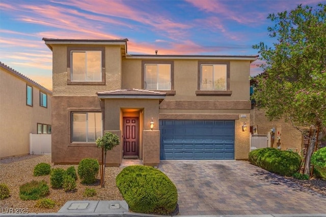 5309 Golden Melody Ln, North Las Vegas, NV 89081 - view of front facade featuring stucco siding, an attached garage, and decorative driveway