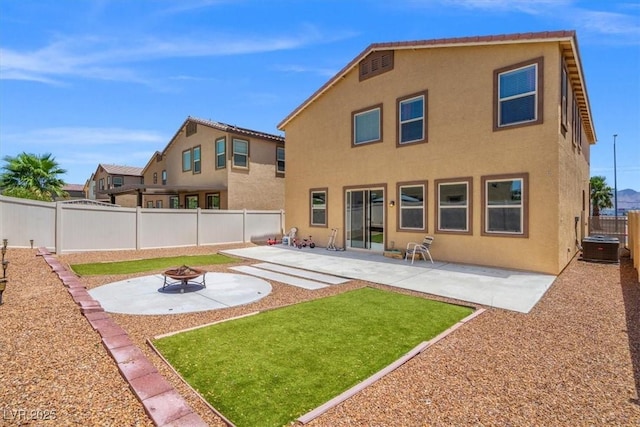 5309 Golden Melody Ln, North Las Vegas, NV 89081 - rear view of house featuring a fire pit, stucco siding, a fenced backyard, and a patio