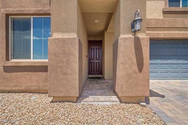 5309 Golden Melody Ln, North Las Vegas, NV 89081 - view of exterior entry with stucco siding and a garage