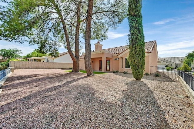 2820 Golf Links Dr, Las Vegas, NV 89134 - view of front facade featuring stucco siding, a tiled roof, a chimney, and a fenced backyard