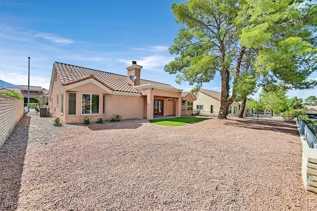 2820 Golf Links Dr, Las Vegas, NV 89134 - back of house featuring a chimney, a tile roof, and stucco siding