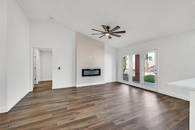 2820 Golf Links Dr, Las Vegas, NV 89134 - unfurnished living room with a glass covered fireplace, ceiling fan, dark wood-type flooring, and high vaulted ceiling