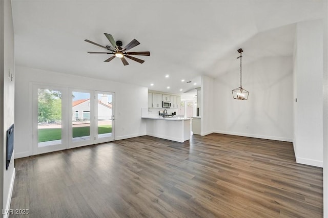 2820 Golf Links Dr, Las Vegas, NV 89134 - unfurnished living room featuring dark wood-style floors, recessed lighting, a ceiling fan, and lofted ceiling