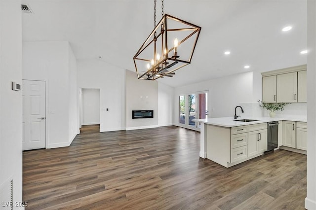 2820 Golf Links Dr, Las Vegas, NV 89134 - kitchen featuring stainless steel dishwasher, a peninsula, open floor plan, light countertops, and dark wood-style floors