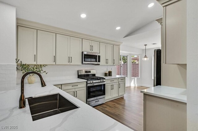 2820 Golf Links Dr, Las Vegas, NV 89134 - kitchen featuring appliances with stainless steel finishes, decorative backsplash, light stone countertops, recessed lighting, and wood finished floors