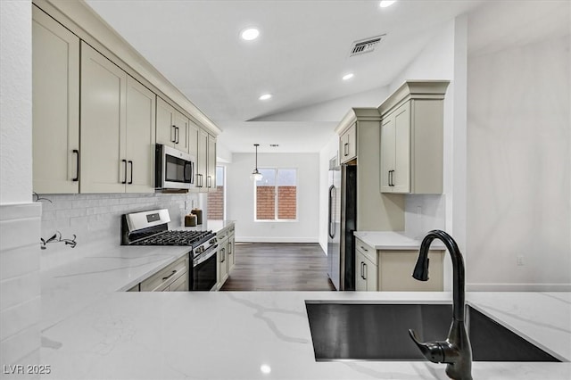 2820 Golf Links Dr, Las Vegas, NV 89134 - kitchen with appliances with stainless steel finishes, decorative backsplash, light stone counters, recessed lighting, and pendant lighting