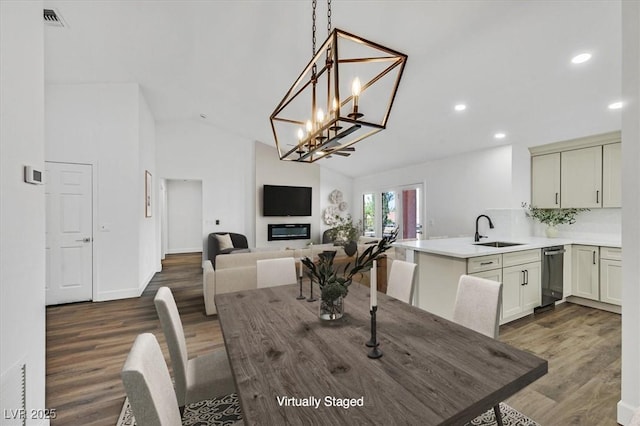 2820 Golf Links Dr, Las Vegas, NV 89134 - dining space with wood finished floors, recessed lighting, high vaulted ceiling, and a chandelier