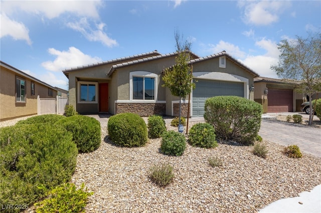 3912 Makushin Bay Ave, North Las Vegas, NV 89081 - ranch-style house featuring an attached garage, stucco siding, stone siding, and a tiled roof