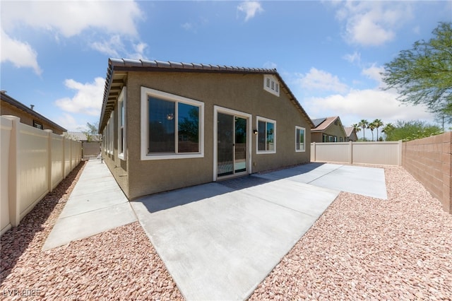 3912 Makushin Bay Ave, North Las Vegas, NV 89081 - back of house with stucco siding, a fenced backyard, and a patio area