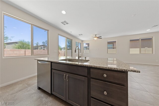 3912 Makushin Bay Ave, North Las Vegas, NV 89081 - kitchen featuring dishwasher, light stone counters, a ceiling fan, light tile patterned flooring, and recessed lighting