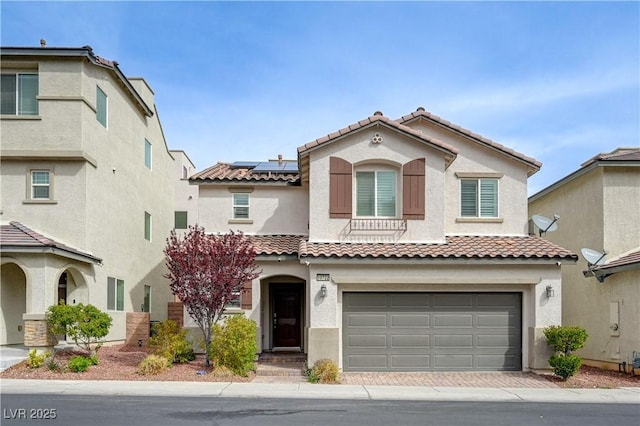 10722 Red Badge Ave, Las Vegas, NV 89166 - mediterranean / spanish-style home with a tile roof, roof mounted solar panels, a garage, and stucco siding