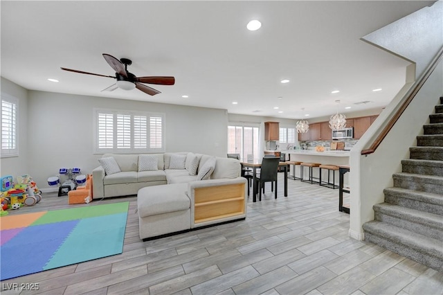 10722 Red Badge Ave, Las Vegas, NV 89166 - living room featuring plenty of natural light, stairway, recessed lighting, a ceiling fan, and light wood-style flooring