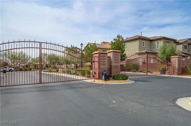 10722 Red Badge Ave, Las Vegas, NV 89166 - view of asphalt street featuring a gate, a gated entry, a residential view, and curbs
