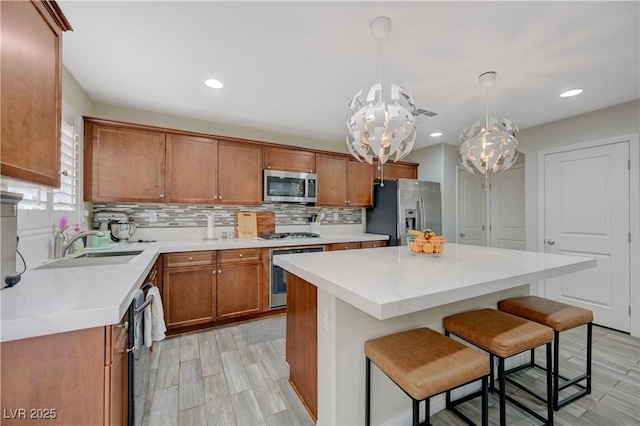 10722 Red Badge Ave, Las Vegas, NV 89166 - kitchen featuring stainless steel appliances, backsplash, light countertops, brown cabinetry, and recessed lighting