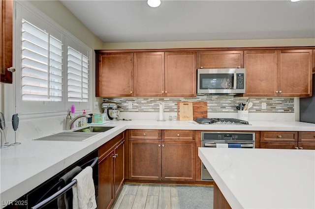10722 Red Badge Ave, Las Vegas, NV 89166 - kitchen with stainless steel appliances, tasteful backsplash, light countertops, and brown cabinetry