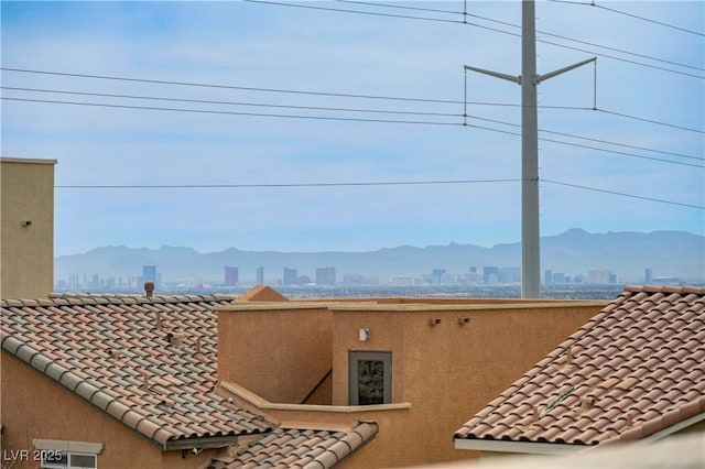 10722 Red Badge Ave, Las Vegas, NV 89166 - detailed view of a tiled roof, a city view, and stucco siding