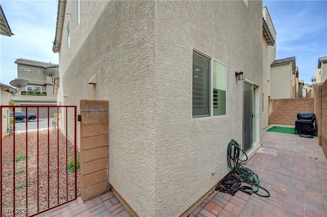 10722 Red Badge Ave, Las Vegas, NV 89166 - view of property exterior featuring stucco siding and a patio area