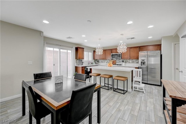 10722 Red Badge Ave, Las Vegas, NV 89166 - dining room with light wood-style floors and recessed lighting