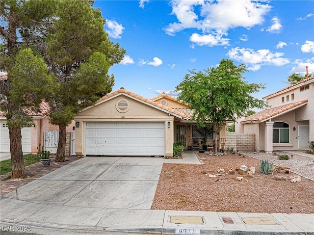 8611 Gabilan Ct, Las Vegas, NV 89123 - view of front of home with concrete driveway, a garage, stucco siding, and a tiled roof