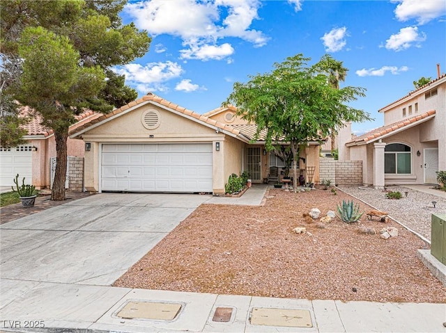8611 Gabilan Ct, Las Vegas, NV 89123 - view of front facade featuring stucco siding, an attached garage, concrete driveway, and a tile roof