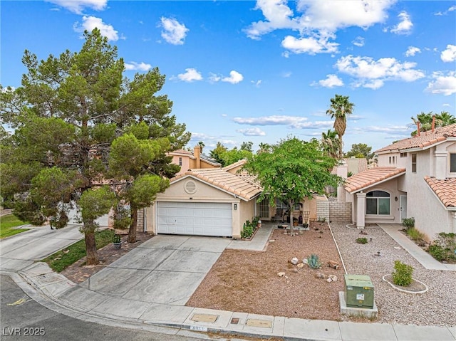 8611 Gabilan Ct, Las Vegas, NV 89123 - view of front of house featuring stucco siding, driveway, a tile roof, and an attached garage