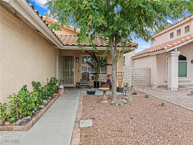 8611 Gabilan Ct, Las Vegas, NV 89123 - doorway to property with stucco siding, a tile roof, and a patio