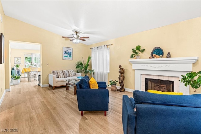 8611 Gabilan Ct, Las Vegas, NV 89123 - living area featuring light wood-style floors, ceiling fan, and a fireplace