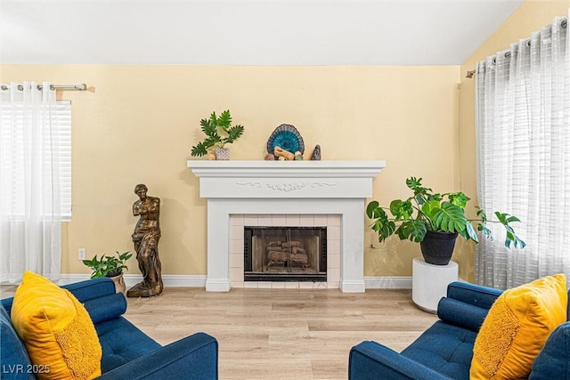 8611 Gabilan Ct, Las Vegas, NV 89123 - living area with wood finished floors, lofted ceiling, and a tiled fireplace