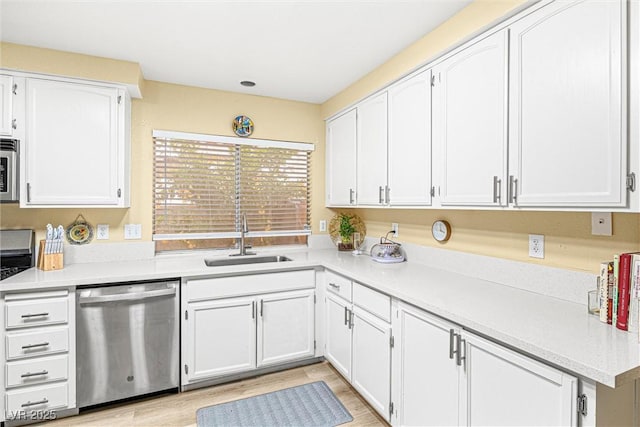 8611 Gabilan Ct, Las Vegas, NV 89123 - kitchen featuring stainless steel appliances, white cabinets, light countertops, and light wood finished floors