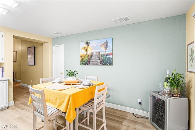 8611 Gabilan Ct, Las Vegas, NV 89123 - dining room with light wood-type flooring and wine cooler