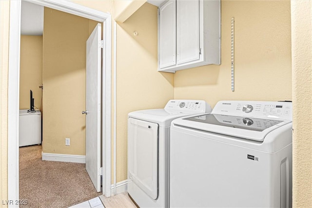 8611 Gabilan Ct, Las Vegas, NV 89123 - laundry area with cabinet space, washing machine and dryer, and light colored carpet