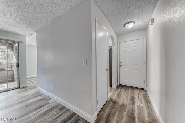 2200 S Fort Apache Rd Unit 2209, Las Vegas, NV 89117 - hall with a textured ceiling, wood finished floors, and arched walkways