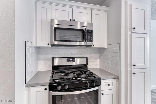 2200 S Fort Apache Rd Unit 2209, Las Vegas, NV 89117 - kitchen with stainless steel appliances, decorative backsplash, and white cabinetry