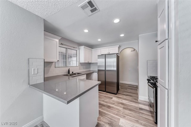 2200 S Fort Apache Rd Unit 2209, Las Vegas, NV 89117 - kitchen featuring freestanding refrigerator, white cabinetry, a peninsula, recessed lighting, and light wood finished floors