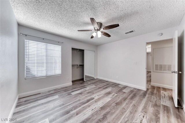 2200 S Fort Apache Rd Unit 2209, Las Vegas, NV 89117 - unfurnished bedroom featuring wood finished floors, a textured ceiling, a closet, and a ceiling fan