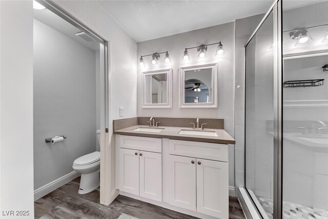 2200 S Fort Apache Rd Unit 2209, Las Vegas, NV 89117 - bathroom with double vanity, wood finished floors, and a shower stall